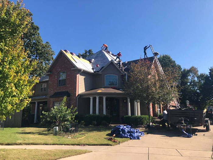 Coastal Construction team members installing a roof with GAF shingles